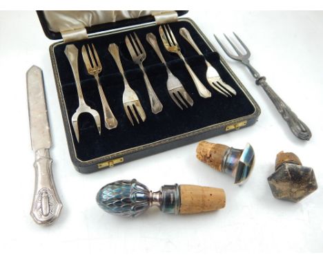 A set of George VI silver dessert forks, a Continental 800 standard paper knife with scarab handle, a silver handled bread fo