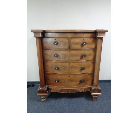 A Victorian mahogany bowfronted five drawer chest with pillar column supports 