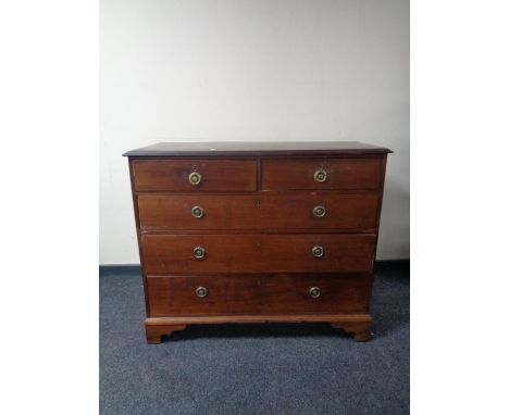 A 19th century five drawer chest with circular brass drop handles on bracket feet.  