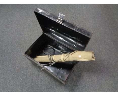 An early 20th century tin trunk together with a folding camp bed 