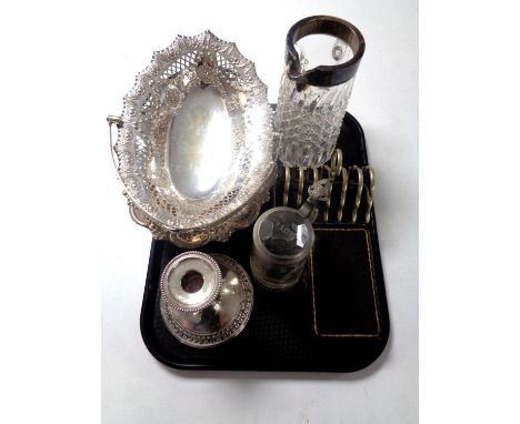 A tray of 20th century plated wares to include swing handled basket, candlestick, toast rack, set of cased cut glass salts wi