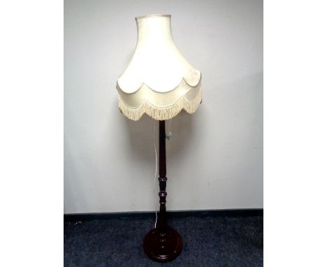 A stained beech standard lamp with shade 