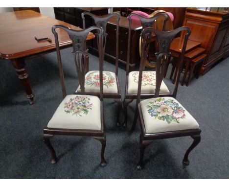 A set of four Edwardian mahogany Queen Anne style dining chairs with tapestry upholstered seats 