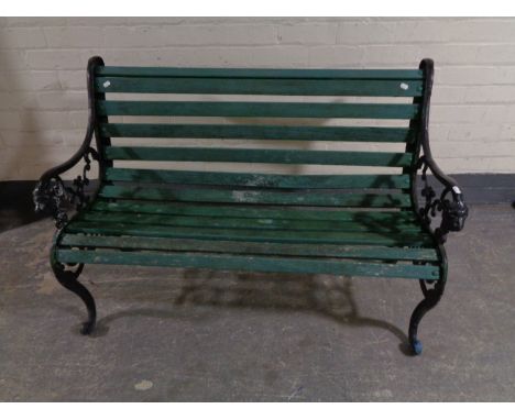 A cast iron wooden slatted garden bench 