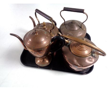 Three antique copper kettles together with a copper teapot.  