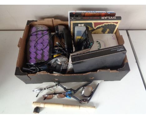 A box containing miscellaneous to include designer glasses, pipes, vapes, digital video recorder, books, hair curlers etc.  