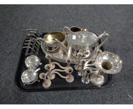 A tray containing plated wares to include three piece tea service on gallery tray, toast rack, bud vase etc.  