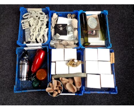 Six plastic crates containing miscellaneous to include tea light holders, napkins and napkin rings, wooden scoops, miniature 