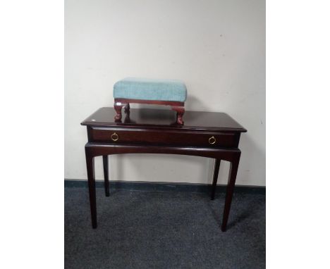 A Stag Minstrel console table and a further upholstered footstool 