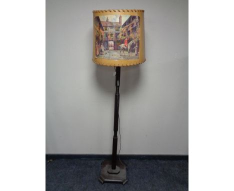 An early 20th century standard lamp with shade depicting a hunting scene.  