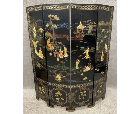 A vintage Chinese ebonised four panel privacy screen, inlaid with carved soapstone and mother of pearl, and hand gilded. H.18