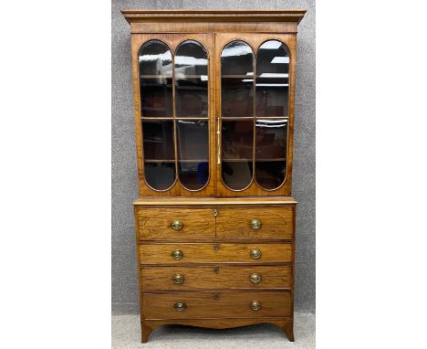 A Georgian mahogany and satinwood inlaid two section library bookcase with upper glazed section above base fitted with secret
