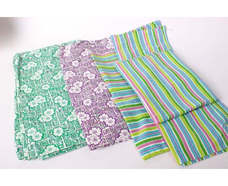 A collection of patchwork pieces and textiles, lengths of American feedsack fabric and eiderdown off-cuts