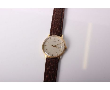 An 18ct gold Vintage Tissot wristwatch. 18ct gold case with metallic grey dial and gold baton markers, date aperture at 3 on 