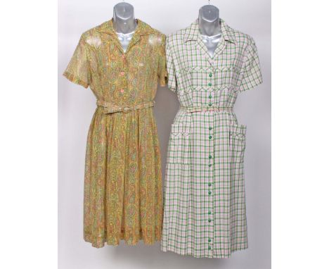 A 1940s cotton floral print housecoat; an early 1950s pale blue silk dress with matching belt, a pink and green checked summe