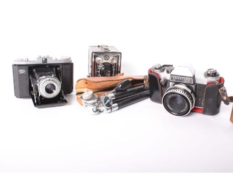 Three vintage cameras. A box Brownie in original brown canvas case, a Praktica PL Noval with Carl Zeiss Jenna lens in origina