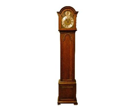 1930's period carved oak longcase clock, the hood with moulded arch shaped pediment, glazed door, trunk with long door and st