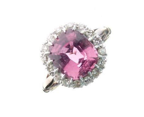 Dress ring set central pink stone with diamond surround, the shank stamped 18ct and Plat, size L½   Condition: 