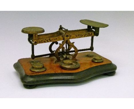 Set of late 19th/ear 20th Century engraved brass postage scales with weights standing on an ebonised and walnut base   Condit