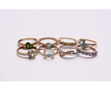 A 9ct white and rose gold diamond set band, together with a 9ct gold tanzanite and diamond ring, a 9ct gold blue topaz ring, 