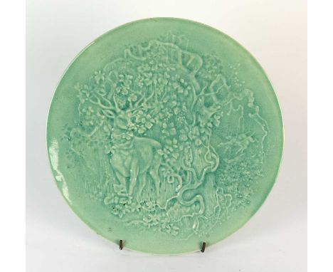 A Burmantofts Faience wall plaque designed by Pierre Mallet, model no.946, modelled in low relief with a stag standing beside