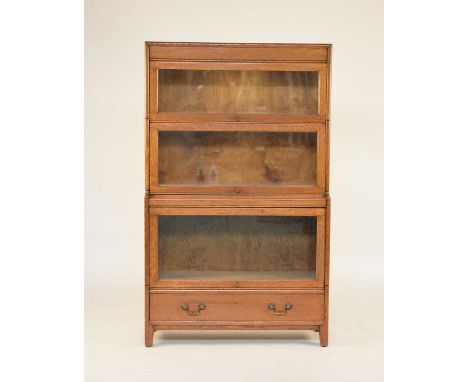 A Globe Wernicke glazed bookcase, in light oak, with three tiers above a single long drawer, 87cm wide x 31cm deep x 142cm hi