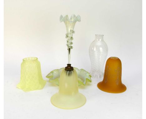 A collection of Victorian and later glass lamp shades, mostly Vaseline glass, together with two post-war glass table lamp bas