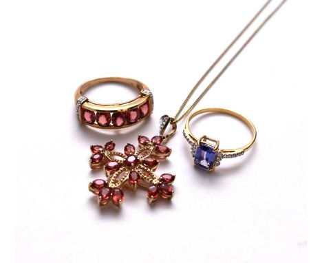 An 18ct gold tanzanite and diamond ring, size N, together with a 9ct gold ruby and diamond ring, size N and a 9ct gold ruby a