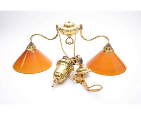 A brass and glass bistro-type adjustable ceiling light, modern, the twin lamp heads with amber coloured conical shades on twi