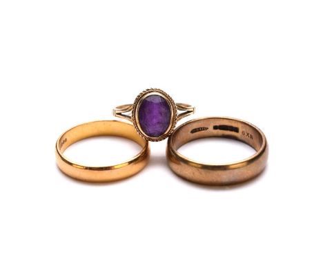 A 22ct gold wedding band, size T 1/2, weight approx 5.3g, together with a 9ct gold wedding band, size U 1/2 and a 9ct gold am