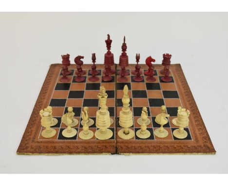 An English carved bone chess set, late 19th century, 32 pieces, one set stained red, kings 10.4cm high, with associated box a