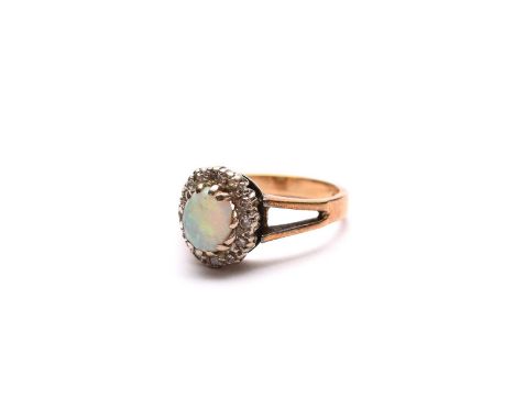 An oval opal and diamond cluster ring, the yellow metal shank stamped '18ct', ring size O 1/2, weight approx 5.2gCondition:Cl