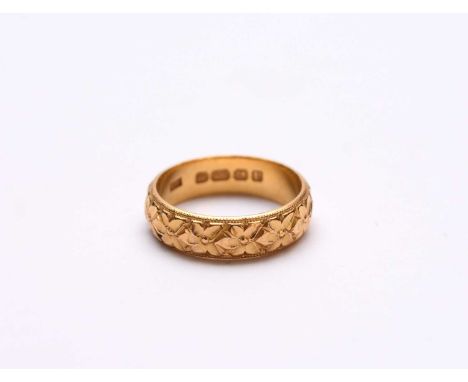 A 22ct gold wedding band, with floral decoration, hallmarked Birmingham 1919, ring size P 1/2, weight approx 7.6g