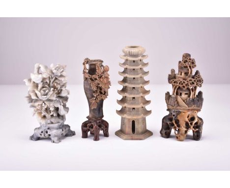 Four Chinese soapstone carvings, first half 20th centuryIncluding a pale grey spray of roses with birds, 20cm high, a dark oc