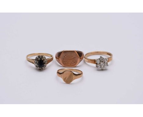 A collection of four 9ct gold rings, comprising; a sapphire and diamond oval cluster ring, a cubic zirconia floral cluster ri