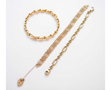 A 9ct gold twisted bangle, together with a 9ct gold four bar gate link bracelet and a yellow metal bracelet stamped '375', to