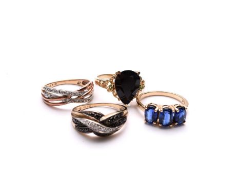 A 9ct gold black diamond ring, together with two 9ct gold diamond dress rings and a 9ct gold untested three stone sapphire ri