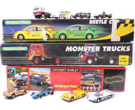 3 Scalextric boxed sets to include, Ford Escort Rally, Monster Trucks and Beetle Cup - all sets have the vehicles and appear 