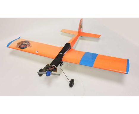 A kit-built balsawood and four stoke radio-controlled aircraft, comprising of balsawood fuselage and decorated with orange So