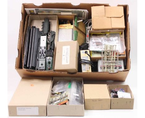 A large tray containing odds and ends from a modeller’s workshop. Includes tools, soldering iron, plastic kits for lineside a