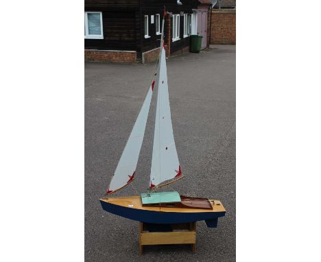 Vic Smeed designed 'Starlet' radio controlled model yacht, with original plans and model stand, fitted and equipped with sail