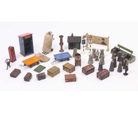 A collection of O gauge small accessories containing luggage trunks, suitcase, milk cans coal office, stamping machine, two b