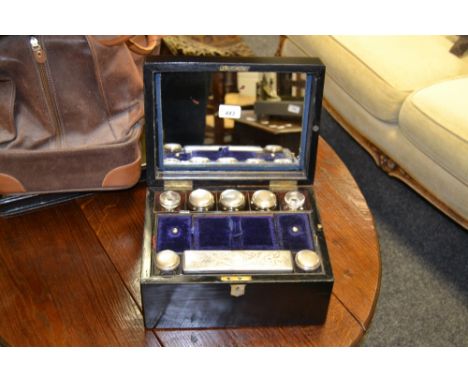 A Victorian rectangular travelling dressing case, mother-of-pearl escutcheon, the interior fitted with mirror, clear glass ja