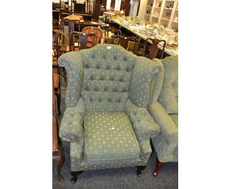 A 20th Century wingback arm chair, button back upholstery in green