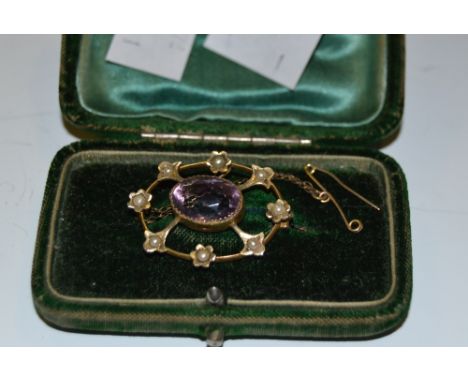 An Edwardian brooch set with seed pearls and amethyst 
