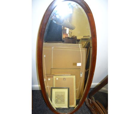 An Edwardian mahogany and satinwood strung oval mirror, 115cm high, 44cm wide, c.1910