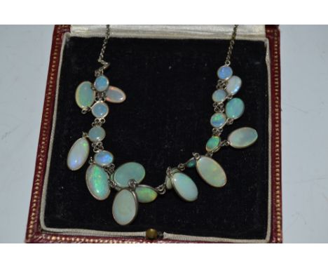 A silver and opal necklace,  graduated stones