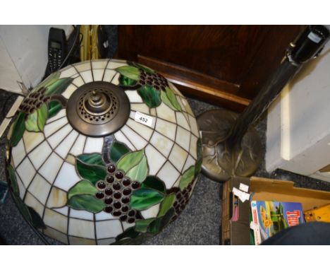 A Tiffany style table lamp, grape vine stained glass shade, bronzed metal tree trunk column