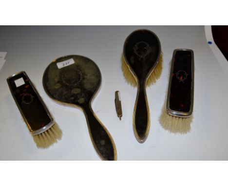 A tortoiseshell and silver 4 piece dressing table set including hand mirror; a silver pen knife (5)