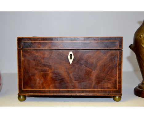 A 19th century mahogany rectangular tea caddy, boxwood strung, ivory lozenge escutcheon, the interior with two lidded compart